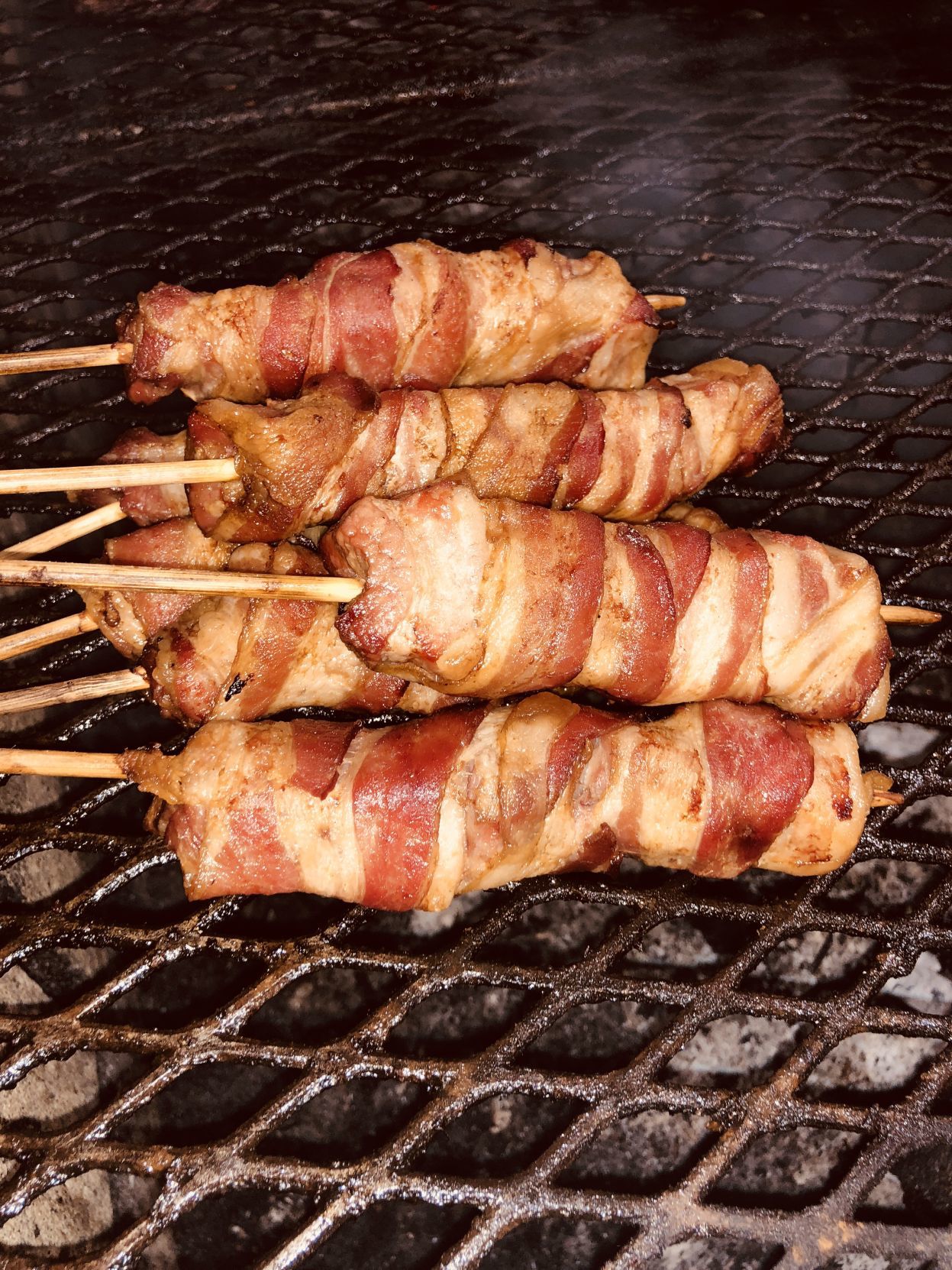 Bacon-wrapped pork belly on a stick
